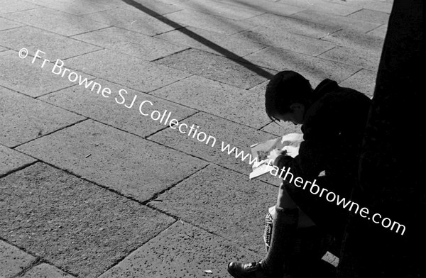 BOY READING AT STATION